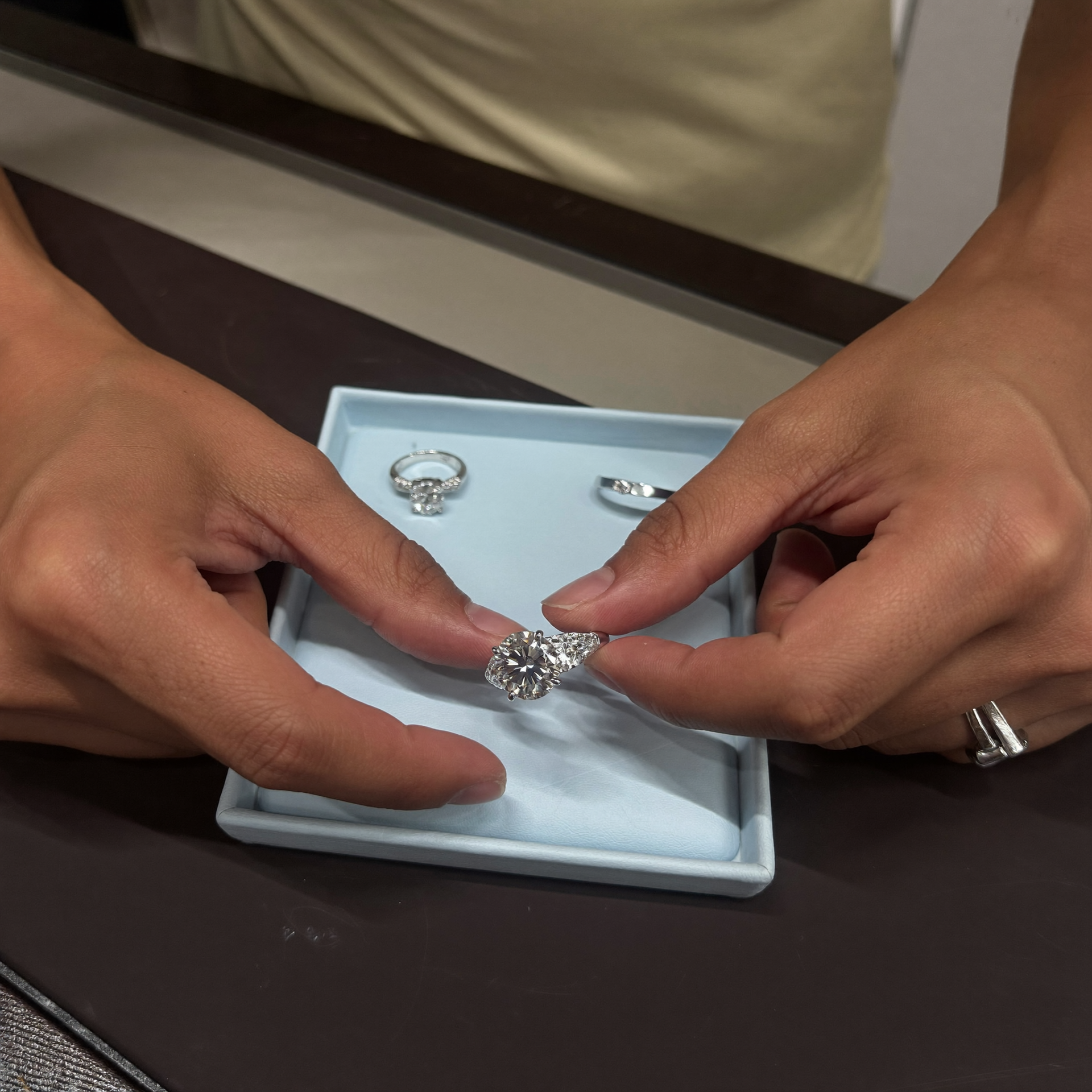 Engagement ring being inspected at a jewelry counter