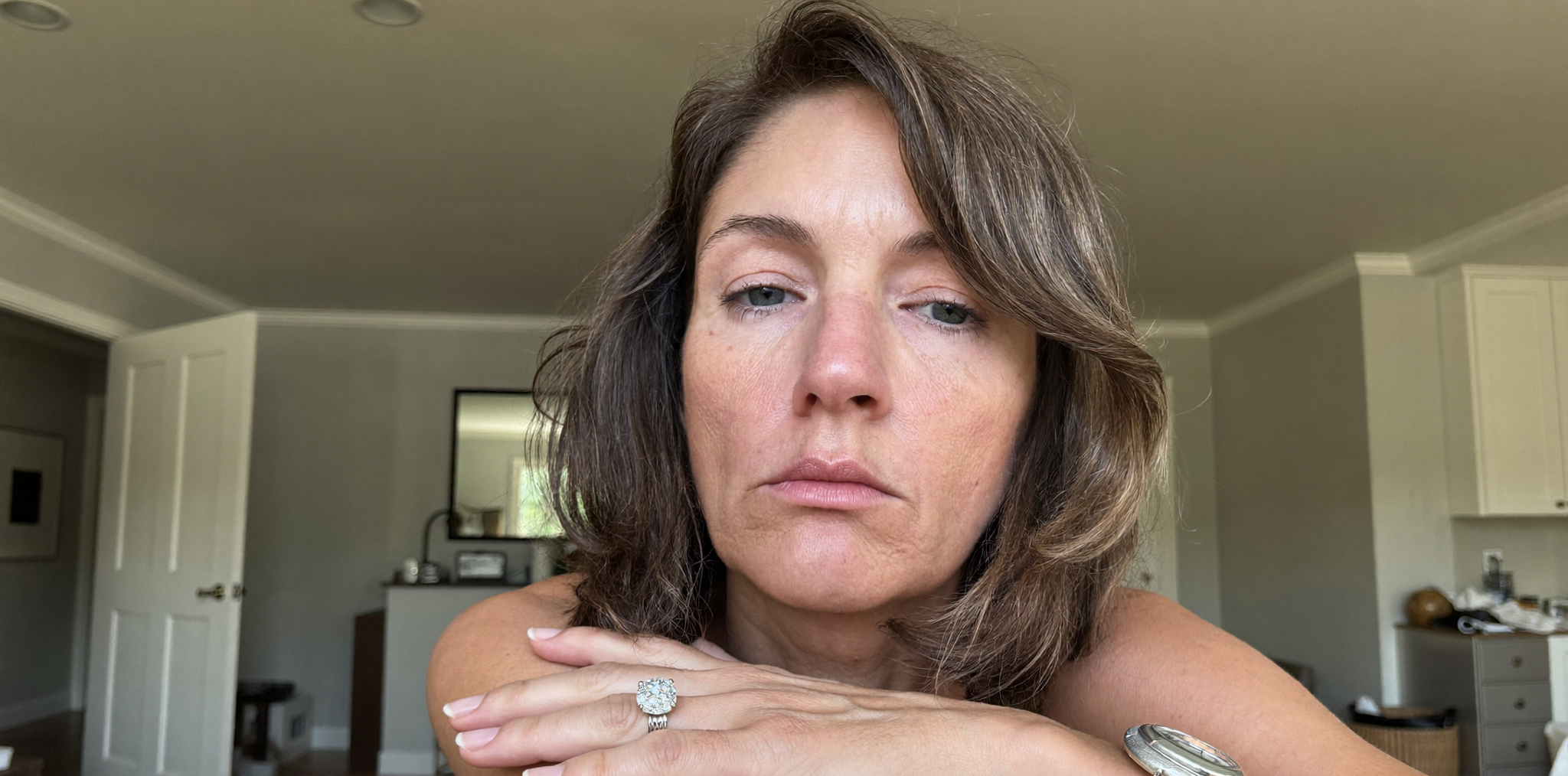 Woman after divorce reflecting while holding her engagement ring